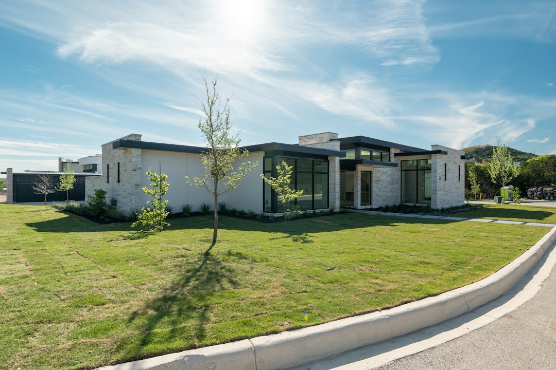 Modern home exterior with green lawn and clean architectural lines